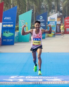 Indian Men's winner Kartik Karkera at the finish line at the Tata Mumbai Marathon 2026
